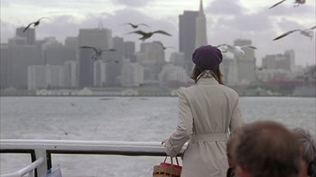 Movie still from “Serendipity” (2001), directed by Peter Chelsom – A woman standing on a pier looking out at the water; Wide shot, Over the shoulder angle