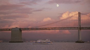 Movie still from “Serendipity” (2001), directed by Peter Chelsom – A boat on a body of water near a bridge; Extreme Wide shot, Low angle