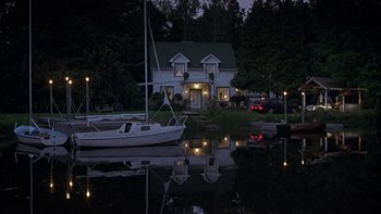 Movie still from “Serendipity” (2001), directed by Peter Chelsom – A house and a boat in the water; Extreme Wide shot, High angle