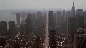 Movie still from “Serendipity” (2001), directed by Peter Chelsom – An aerial view of a busy city with tall skyscrapers; Extreme Wide shot, High angle