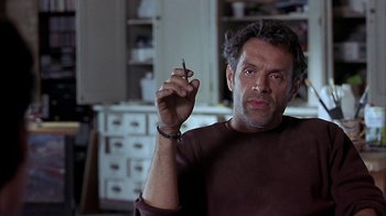 Movie still from “Serendipity” (2001), directed by Peter Chelsom – A man holding a cigarette in his hand; Close Up shot, Low angle