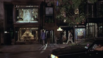 Movie still from “Serendipity” (2001), directed by Peter Chelsom – A couple of people walking down a street at night; Extreme Wide shot, High angle