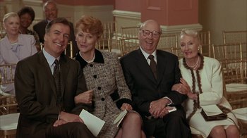 Movie still from “Serendipity” (2001), directed by Peter Chelsom – A group of people sitting next to each other; Medium shot, Low angle