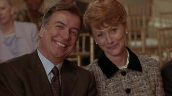 Movie still from “Serendipity” (2001), directed by Peter Chelsom – A man and a woman smile for a picture; Close Up shot, Low angle