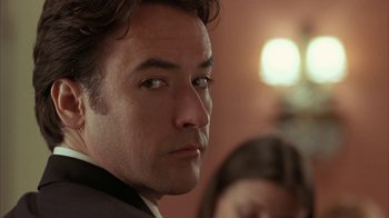 Movie still from “Serendipity” (2001), directed by Peter Chelsom – A person wearing a suit and tie; Close Up shot, Over the shoulder angle