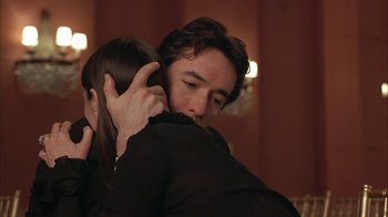 Movie still from “Serendipity” (2001), directed by Peter Chelsom – A man and a woman hugging each other in front of a mirror; Close Up shot, Over the shoulder angle