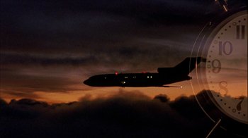 Movie still from “Serendipity” (2001), directed by Peter Chelsom – An airplane is flying through the night sky; Extreme Wide shot, Low angle