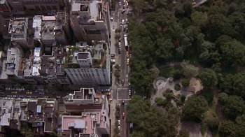 Movie still from “Serendipity” (2001), directed by Peter Chelsom – An aerial view of a busy city street with cars driving down the road; Extreme Wide shot, Overhead angle