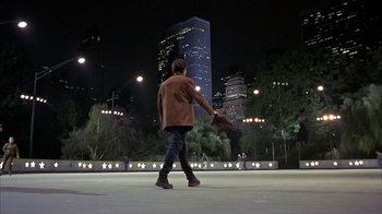 Movie still from “Serendipity” (2001), directed by Peter Chelsom – A man walking in a park at night; Extreme Wide shot, Over the shoulder angle