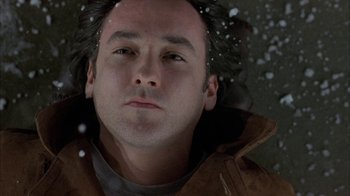 Movie still from “Serendipity” (2001), directed by Peter Chelsom – A person wearing a brown jacket; Close Up shot, Overhead angle