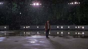 Movie still from “Serendipity” (2001), directed by Peter Chelsom – A man standing in the snow at night; Extreme Wide shot, High angle