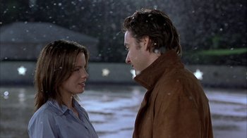 Movie still from “Serendipity” (2001), directed by Peter Chelsom – A man and a woman standing next to each other in the snow; Medium shot, Over the shoulder angle