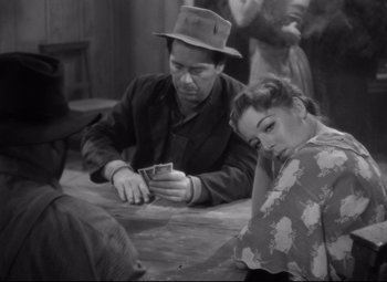 Movie still from “Sergeant York” (1941), directed by Howard Hawks – A man and a woman sitting at a table playing cards; Medium shot, High angle