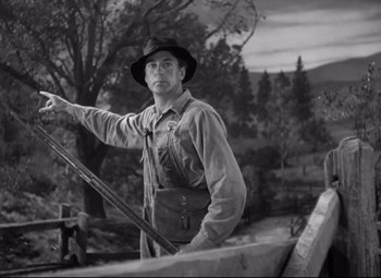 Movie still from “Sergeant York” (1941), directed by Howard Hawks – A man in a hat holding onto a pole; Medium shot, Low angle