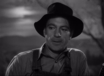 Movie still from “Sergeant York” (1941), directed by Howard Hawks – A black and white photo of a man wearing a hat and overalls; Close Up shot, Low angle