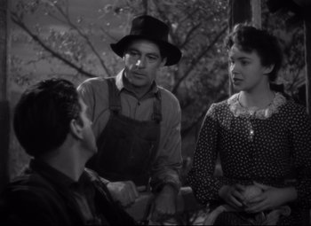 Movie still from “Sergeant York” (1941), directed by Howard Hawks – A man and two women sitting next to each other; Medium shot, Over the shoulder angle