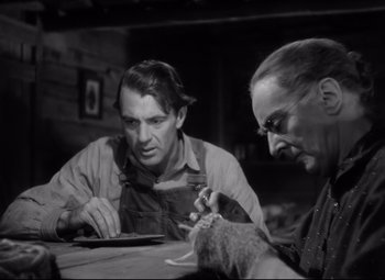 Movie still from “Sergeant York” (1941), directed by Howard Hawks – Two men sitting at a table looking at a tablet; Close Up shot, Low angle