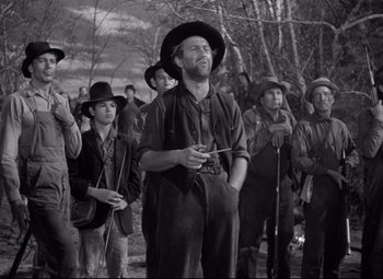 Movie still from “Sergeant York” (1941), directed by Howard Hawks – A group of men standing next to each other in a field; Medium shot, Low angle