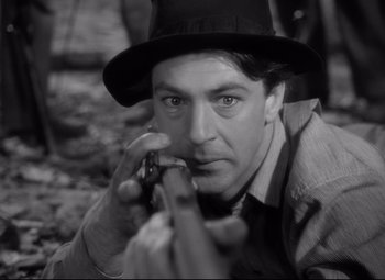 Movie still from “Sergeant York” (1941), directed by Howard Hawks – A black and white photo of a man holding a gun; Close Up shot, Low angle