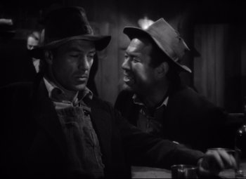 Movie still from “Sergeant York” (1941), directed by Howard Hawks – A couple of men standing next to each other in a room; Medium shot, Over the shoulder angle