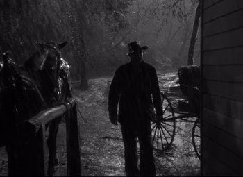 Movie still from “Sergeant York” (1941), directed by Howard Hawks – A man standing next to a horse and buggy; Wide shot, Low angle