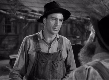 Movie still from “Sergeant York” (1941), directed by Howard Hawks – A man wearing a hat standing next to a woman; Close Up shot, Over the shoulder angle