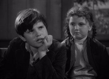 Movie still from “Sergeant York” (1941), directed by Howard Hawks – A boy and a little girl sitting next to each other; Close Up shot, High angle