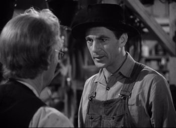 Movie still from “Sergeant York” (1941), directed by Howard Hawks – An older man wearing a hat talking to an older woman wearing an overalls; Close Up shot, Over the shoulder angle