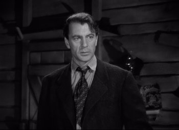Movie still from “Sergeant York” (1941), directed by Howard Hawks – A black and white photo of a man in a suit and tie; Close Up shot, Over the shoulder angle