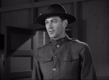 Movie still from “Sergeant York” (1941), directed by Howard Hawks – A man wearing a hat and a military uniform; Medium shot, Low angle