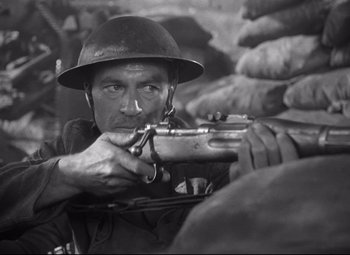 Movie still from “Sergeant York” (1941), directed by Howard Hawks – An old photo of a man holding a rifle; Close Up shot, High angle