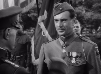 Movie still from “Sergeant York” (1941), directed by Howard Hawks – Black and white photograph of a man in military uniform; Close Up shot, Over the shoulder angle