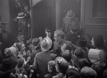 Movie still from “Sergeant York” (1941), directed by Howard Hawks – A group of people standing around a train; Wide shot, High angle