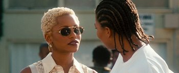 Movie still from “Set It Off” (1996), directed by F. Gary Gray – Two women talking to each other wearing sun glasses; Close Up shot, Over the shoulder angle