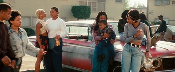 Movie still from “Set It Off” (1996), directed by F. Gary Gray – A group of people standing next to an old car; Wide shot, Low angle