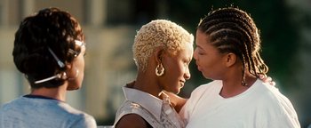 Movie still from “Set It Off” (1996), directed by F. Gary Gray – Two women are embracing each other in a park; Close Up shot, Over the shoulder angle
