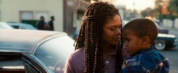 Movie still from “Set It Off” (1996), directed by F. Gary Gray – A young woman with long braids standing next to another young woman; Close Up shot, Over the shoulder angle