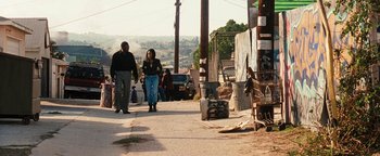 Movie still from “Set It Off” (1996), directed by F. Gary Gray – Two people walking down a street near a building; Wide shot, High angle