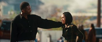 Movie still from “Set It Off” (1996), directed by F. Gary Gray – A man and a woman fighting in the street; Medium shot, Over the shoulder angle