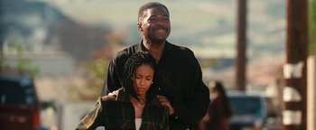 Movie still from “Set It Off” (1996), directed by F. Gary Gray – A man and a woman are hugging and smiling; Medium shot, Low angle