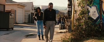 Movie still from “Set It Off” (1996), directed by F. Gary Gray – A man and a woman walking down a street; Wide shot, Over the shoulder angle