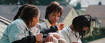 Movie still from “Set It Off” (1996), directed by F. Gary Gray – A group of young people sitting on a bench; Close Up shot, Over the shoulder angle