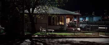 Movie still from “Set It Off” (1996), directed by F. Gary Gray – A house sitting on the side of a road at night; Extreme Wide shot, Low angle