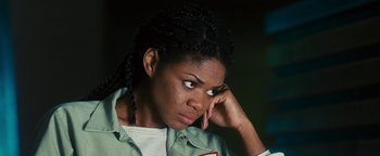 Movie still from “Set It Off” (1996), directed by F. Gary Gray – A black woman with braids is holding her hand to her face; Close Up shot, High angle