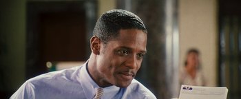 Movie still from “Set It Off” (1996), directed by F. Gary Gray – A person wearing a shirt and tie; Close Up shot, Over the shoulder angle