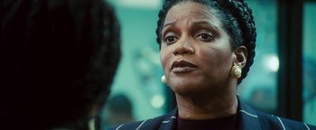 Movie still from “Set It Off” (1996), directed by F. Gary Gray – A person wearing a suit; Close Up shot, Over the shoulder angle