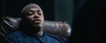 Movie still from “Set It Off” (1996), directed by F. Gary Gray – A person sitting in a chair; Close Up shot, Over the shoulder angle