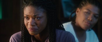 Movie still from “Set It Off” (1996), directed by F. Gary Gray – A person with braids looking angry; Close Up shot, Over the shoulder angle