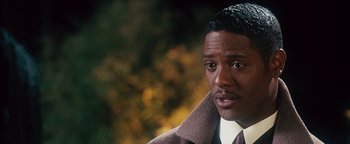 Movie still from “Set It Off” (1996), directed by F. Gary Gray – A person wearing a suit and tie; Close Up shot, Over the shoulder angle