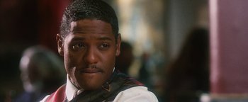 Movie still from “Set It Off” (1996), directed by F. Gary Gray – A person wearing a shirt and tie; Close Up shot, Over the shoulder angle